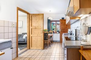a kitchen with a door open to a dining room at Ferienhaus Himmelreich in Barlt