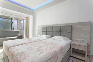 a bedroom with a large bed and a window at Villa Dionysia Studio S3 in Alikanas +21 photos
