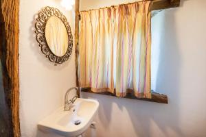 a bathroom with a sink and a mirror at Dependance avec Jacuzzi in Arcangues