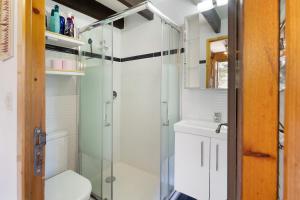 a bathroom with a glass shower and a toilet at Petit chalet mitoyen Pyrénées 2000 in Bolquere Pyrenees 2000