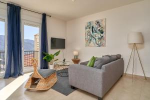 a living room with a couch and a chair at Casa Palmeras in Almuñécar