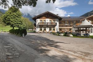 a large building with a tree in front of it at Agritur Maso Pan in Caderzone Terme