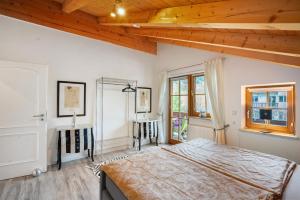 a bedroom with a large bed and a window at Place In The Bavarian Mountains in Schneizlreuth