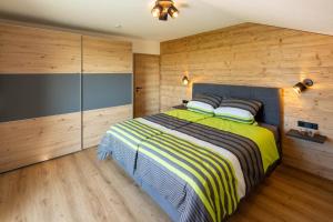 a bedroom with a large bed with wooden walls at Ferienwohnung Egg-Hof in Bad Grönenbach