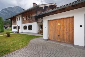a house with a large wooden garage door at Place In The Bavarian Mountains in Schneizlreuth