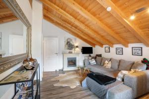 a living room with a couch and a fireplace at Place In The Bavarian Mountains in Schneizlreuth