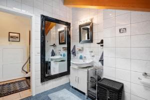 a bathroom with two sinks and a mirror at Place In The Bavarian Mountains in Schneizlreuth +19 photos