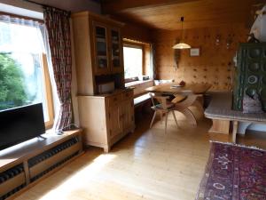 a kitchen with a table and a dining room at Ferienhaus am Bach in Wieden