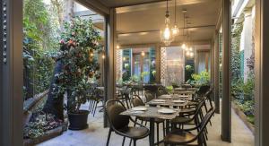 a restaurant with tables and chairs and a christmas tree at BB Hotels Smarthotel Missori in Milan