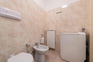 a bathroom with a toilet and a sink at Nice apartment Le Vele Garda Lake in Toscolano Maderno +16 photos