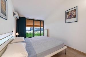 a bedroom with a bed and a window at Nice apartment Le Vele Garda Lake in Toscolano Maderno