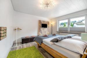 a bedroom with a large bed and a window at Ferienwohnung My Suite Home in Illingen