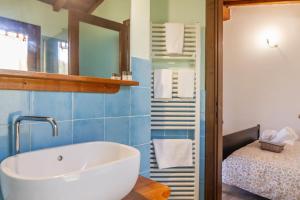 a bathroom with a tub and a bed and a mirror at Vento di Maremma in Marina di Grosseto +174 photos