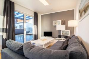 a living room with a couch and a large window at Ferienhaus Spaden in Spaden