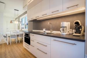 a kitchen with white cabinets and a counter top at Ferienhaus Spaden in Spaden