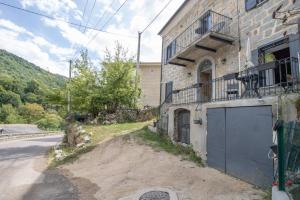 a building with a garage on the side of a road at A Casa D'amore in Bastelica