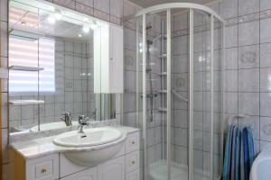 a bathroom with a sink and a shower at Villa Balboa in Sondernach +24 photos