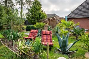 two chairs and a table in a garden at Haus Sonnenschein in Pahlen