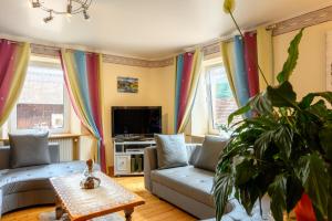 a living room with a couch and a table at Villa Balboa in Sondernach