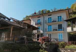 a large white building with windows and balconies at Cà di Cambret with lake View in Stresa
