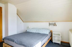a bedroom with a bed in a small room at Marienstraße, 54m², ruhig gelegen in Herdwangen-Schönach