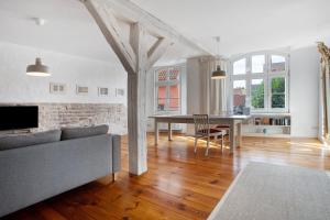 a living room with a couch and a table at Alte Seifensiederei 3 in Stralsund