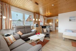 a living room with a couch and a table at Ferienhaus Landhaus Loose in Schashagen