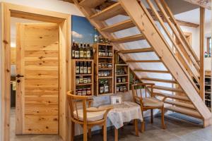 a tasting room with a table and chairs and a staircase at Malsötscherhof Apt A in Villandro