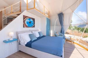 a bedroom with a bed in a tent at Dome on the hill with Jacuzzi in Castellammare del Golfo