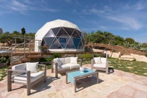 a circular observatory with chairs and a table in front of it at Dome on the hill with Jacuzzi in Castellammare del Golfo