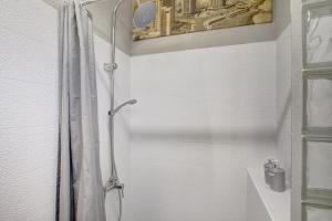 a shower with a shower curtain in a bathroom at Estudio Calima in Arico +19 photos