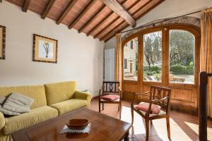 a living room with a couch and a table at Podere San Bartolo- Fienile in Barberino di Val dʼElsa
