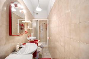 a bathroom with two toilets and a sink and a mirror at Casa Rose di Mare in Albenga +14 photos