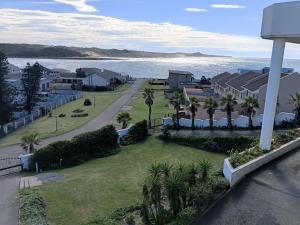 an aerial view of a beach with palm trees and houses at The White House Guesthouse in East London