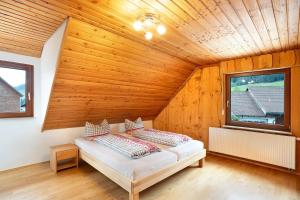 a bedroom with a bed in a wooden room at Wohnung Kuhblick in Baiersbronn