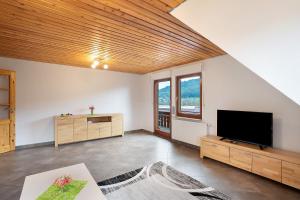 a large living room with a flat screen tv at Wohnung Kuhblick in Baiersbronn