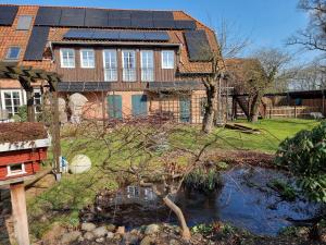 a house with solar panels on top of it at Ferienwohnung Oertzheide in Hermannsburg