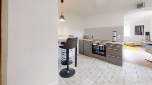 a kitchen with a bar stool in the middle of it at Urlaub auf dem Land in Triepkendorf