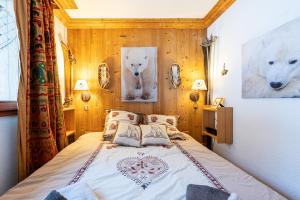 a bedroom with a bed with two polar bears on the wall at Le Châtelard in Val-d'Isère