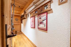 a hallway with posters on the wall of a house at Le Châtelard in Val-d'Isère +20 photos