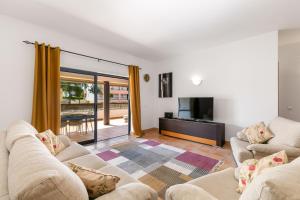 a living room with two couches and a television at Marina park Apartment in Lagos