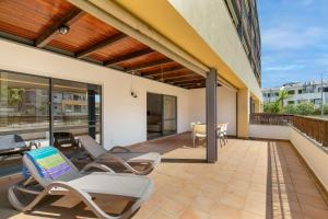 a patio with chaise lounge chairs on a balcony at Marina park Apartment in Lagos