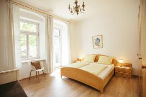 a bedroom with a large bed and two windows at Freienfeldhof Golden in Lagundo