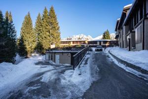 a snow covered street in front of a building at 3Tre Patascoss-Madonna di Campiglio in Madonna di Campiglio