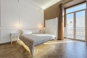 a bedroom with a bed and a large window at Orchidea Celeste Bed and Breakfast in Manfredonia