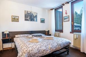 a bedroom with a bed with towels on it at 3Tre Patascoss-Madonna di Campiglio in Madonna di Campiglio