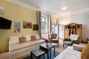 a living room with a couch and a table at Starenhof Ferienhaus in Schlagsdorf