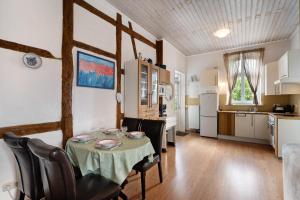 a kitchen and dining room with a table and chairs at Starenhof Ferienhaus in Schlagsdorf