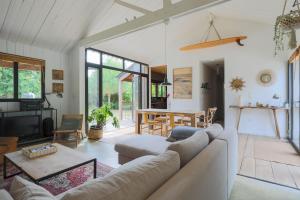 a living room with a couch and a table at Maison Vacances Gaetan in Binic