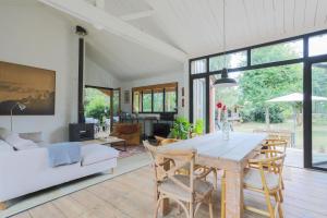 a dining room and living room with a table and chairs at Maison Vacances Gaetan in Binic